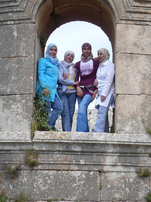 Young girls pose in the window at the Basilica St Simeon where the saint was said to have lived on a platform atop of a pillar 15 metres high for 37 years